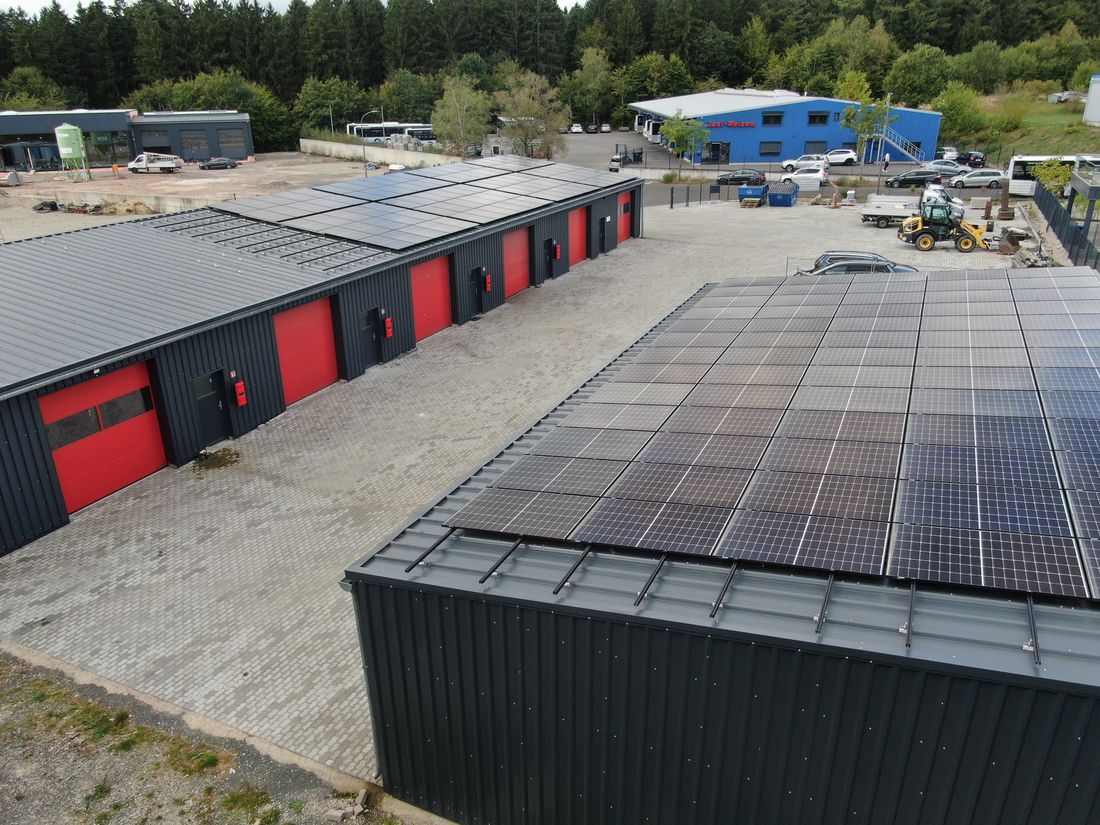 Luftbild des Gewerbeparks mit zwei Hallen und Photovoltaik auf den Dächern